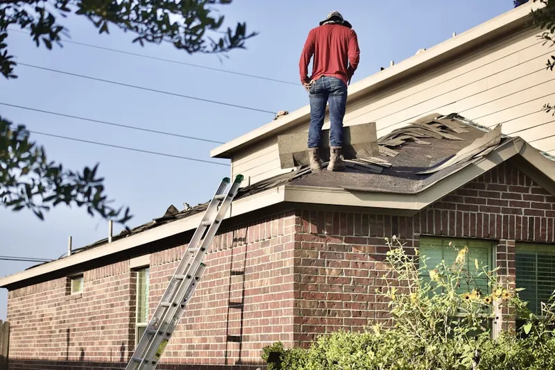 Professional roofer working on a residential roof in Napoleon